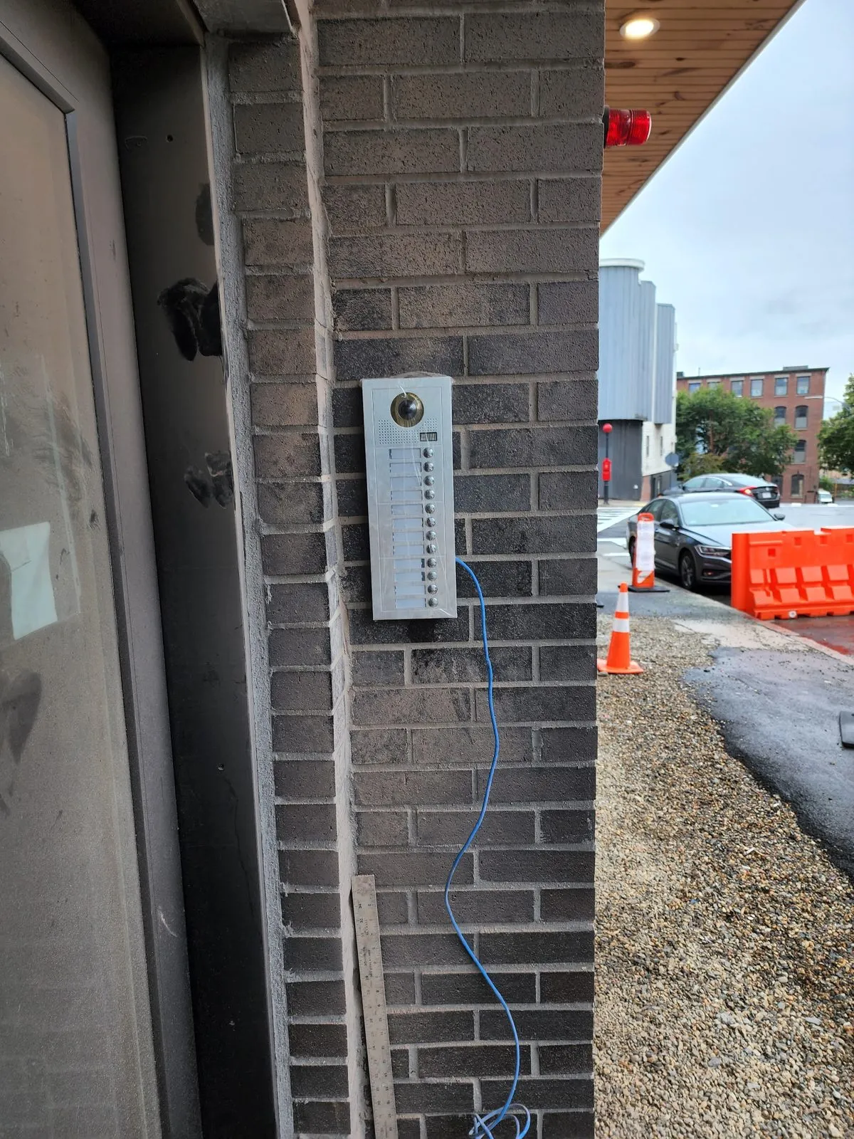 New intercom panel going in on brick — an EMC job in progress