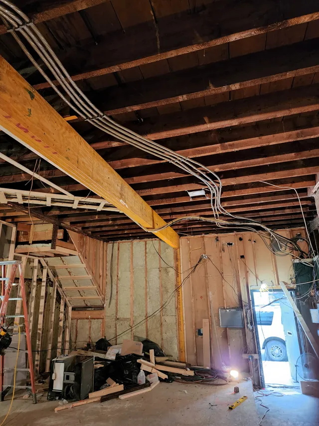 Planned electrical cable runs pulled through open framing on an EMC job